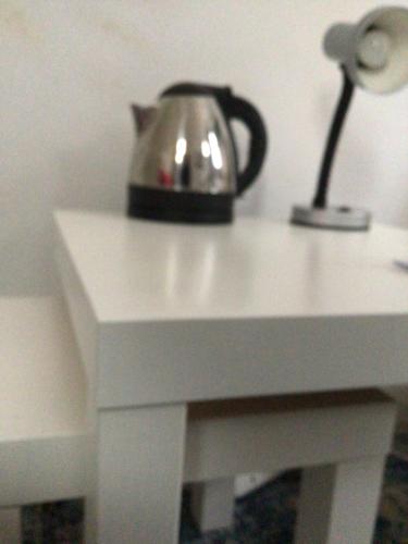 a silver tea kettle sitting on top of a white table at Cleddon in Bournemouth