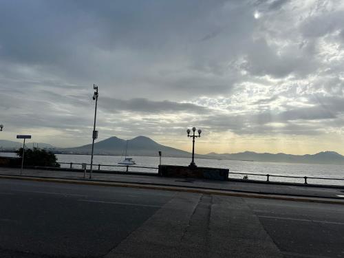 an empty street with a view of the water and mountains at La casa di Sarah aspetta voi in Naples