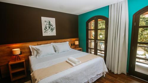 Una cama o camas en una habitación de Flores da Praça