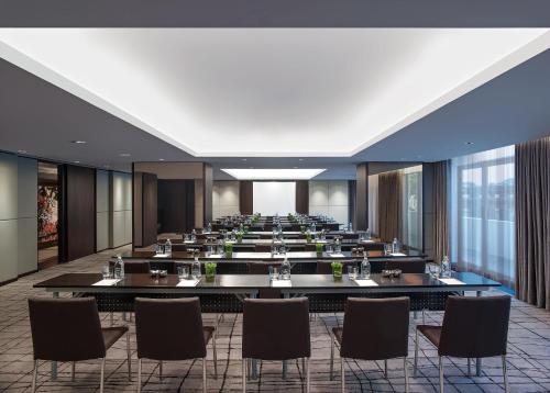 a large conference room with a long table and chairs at New World Makati Hotel, Manila in Manila