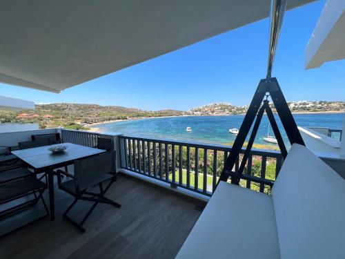 a balcony with a table and a view of the water at Sounio - Waterfront Luxury Spa Villa Pounta Zeza 170 sqm on Private Beach in Sounio