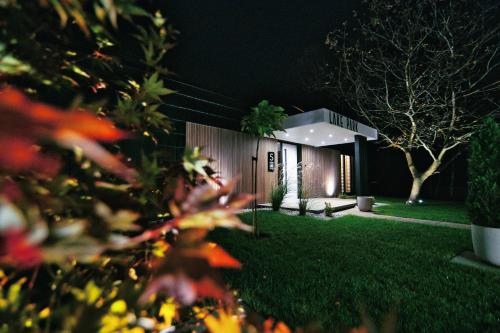 a house is lit up at night at Lake Park in Zator