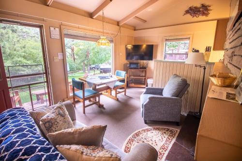 a living room with a couch and a table at Castle Mountain Lodge in Estes Park