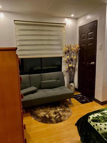 a living room with a couch and a fireplace at Flores Staycation in Marilao