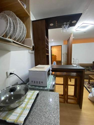 a kitchen with a counter top with a microwave at Flores Staycation in Marilao