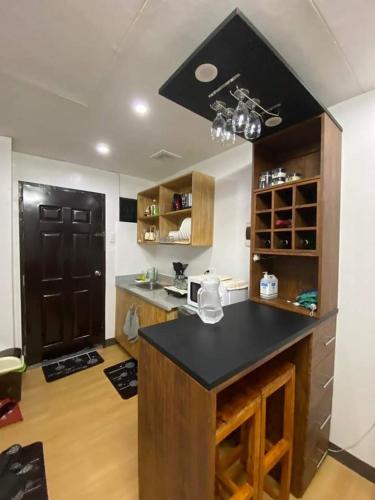 a kitchen with a island with a black counter top at Flores Staycation in Marilao