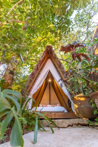 a small tent in the middle of some trees at Hostel Da Vila Ilhabela in Ilhabela