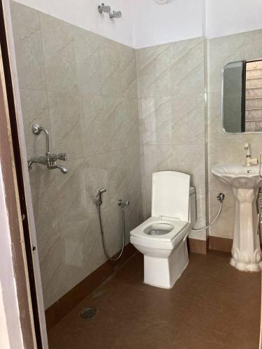 a bathroom with a toilet and a sink at Cozy Room in 3BHK duplex in Dehradun