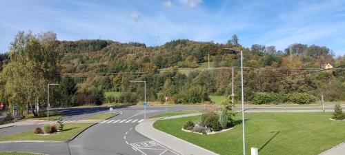 an empty road with street lights and a mountain at Penzion Bystřička in Vsetín
