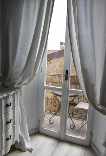 a room with a door open to a balcony at Le Stanze del Cardinale in Pavia