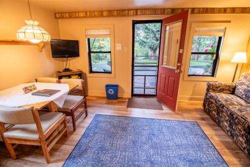 a living room with a table and a couch at Castle Mountain Lodge in Estes Park