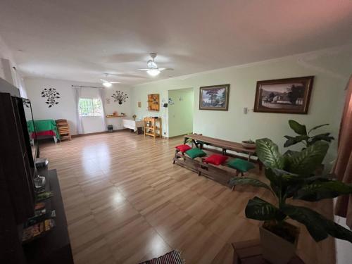 a living room with a couch and a wooden floor at Hotel Marquês de Maricá in Maricá