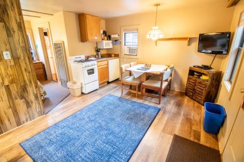 a kitchen with a table and a dining room at Castle Mountain Lodge in Estes Park