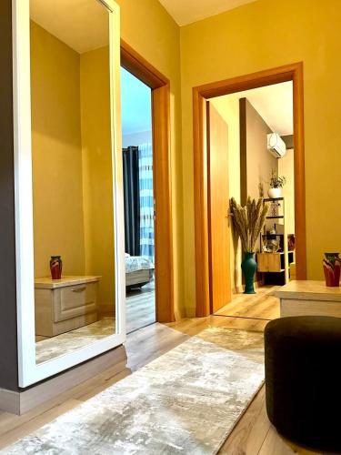 a mirror in a living room with a room at My Guest Base in Tirana