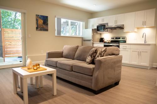 a living room with a couch and a table at Creek Side 2-Bedroom Guest Suite in Burnaby