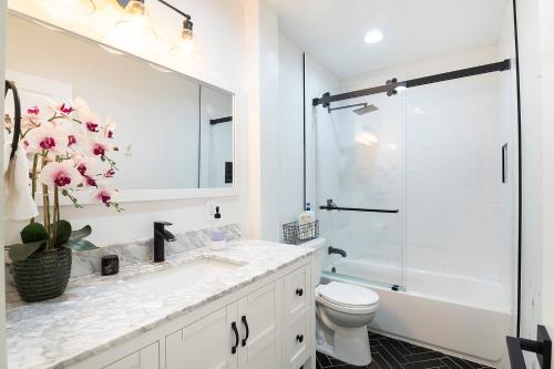 a bathroom with a sink and a toilet and a shower at Beautiful Large Home + Pool in Los Angeles