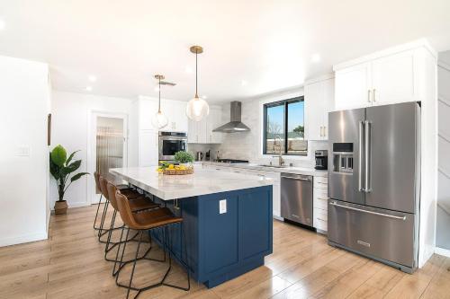 a kitchen with a blue island and stainless steel appliances at Beautiful Large Home + Pool in Los Angeles