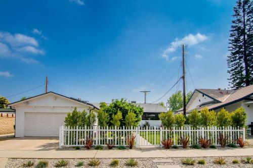 a white fence in front of a house at Beautiful Large Home + Pool in Los Angeles