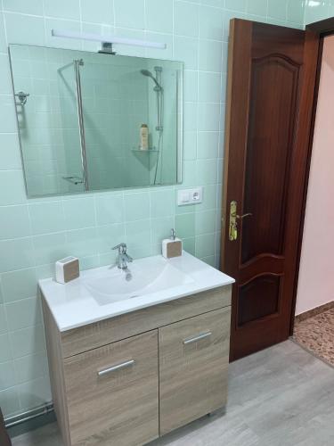 a bathroom with a sink and a mirror at Balcón da Ría in Badernado