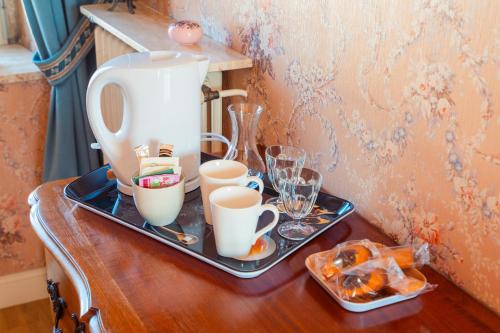 a table with a tea pot and cups on it at RELAIS SAINT JACQUES in Amboise