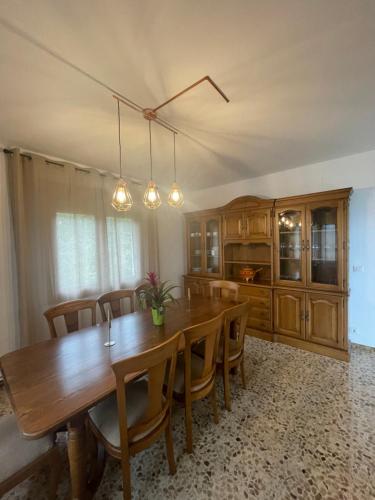 a dining room with a wooden table and chairs at Balcón da Ría 