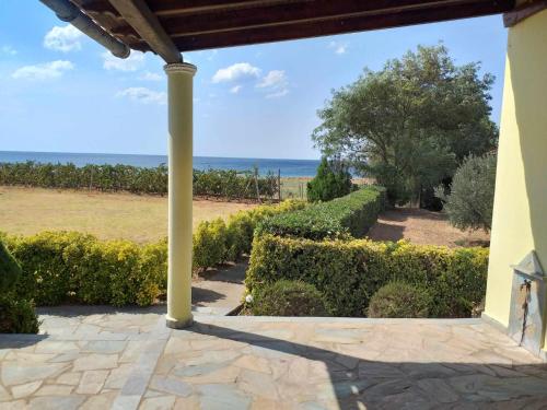a porch with a view of the ocean at Luxury Villa Ntina in Maronia