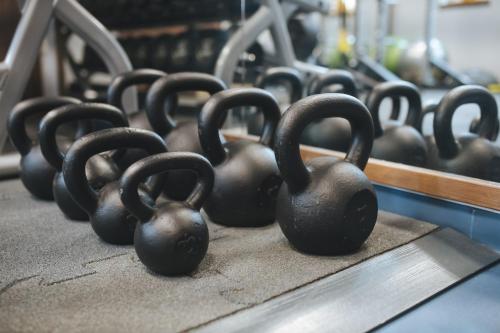 a row of black weights sitting on a table at Imola Hotel Platán in Eger