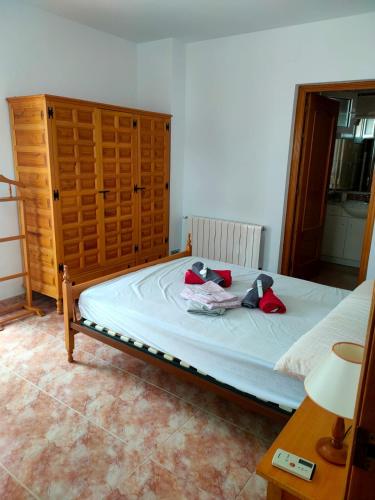 a bed with two stuffed animals on top of it at Villa Coco in Les tres Cales