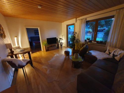 a living room with a couch and a tv at Alpenblick in Oberammergau