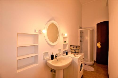 a white bathroom with a sink and a mirror at Stazione, Chieri - Casa Vittoria in Chieri