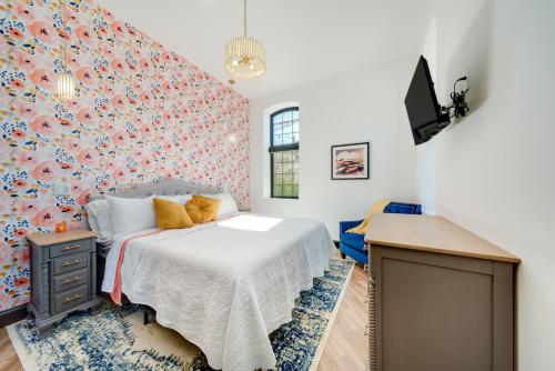 a bedroom with a bed with a floral wall at Idyllic Biggsville Vacation Rental 10 Mi to River in Biggsville