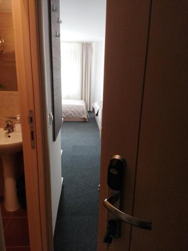 a door to a room with a bed and a bathroom at Apartman Masa Kopaonik in Kopaonik