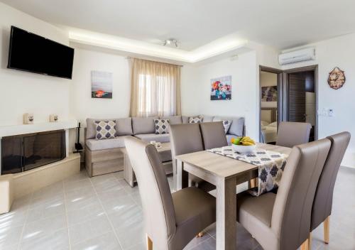 a living room with a table and a dining room at Blue Horizon Lefkopetra in Triopetra