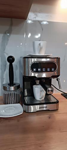 a coffee maker sitting on top of a table at RB Apartment 1 (SPA) & 2 in Palić