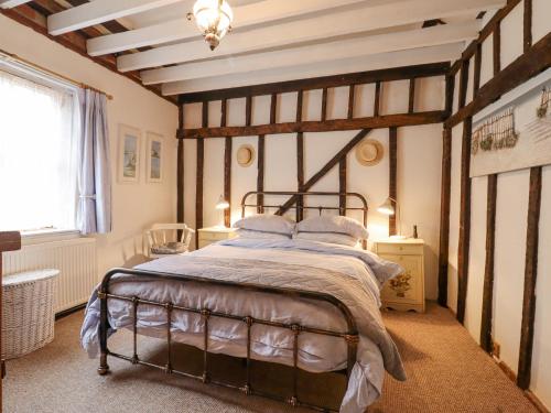 a bedroom with a large bed in a room at Driftwood Cottage in Harwich