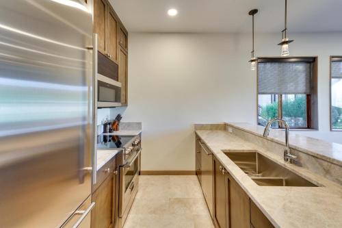 a kitchen with a sink and a refrigerator at Sun Valley Condo with Furnished Patio Near Skiing! in Sun Valley