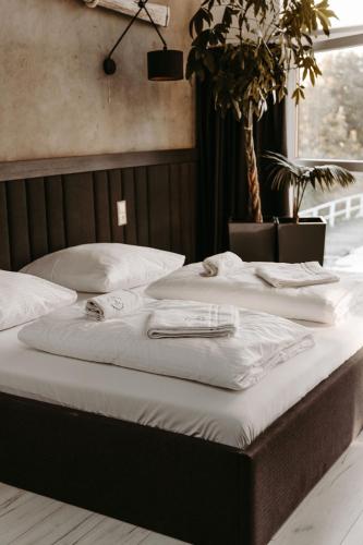 two beds with white sheets and towels on them at Apartamenty Kapitańskie - Pływające in Oława