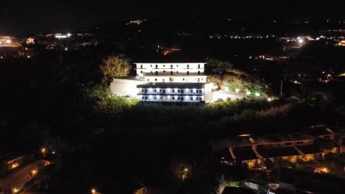 a large white building at night with lights at BellaVista in Capo Vaticano