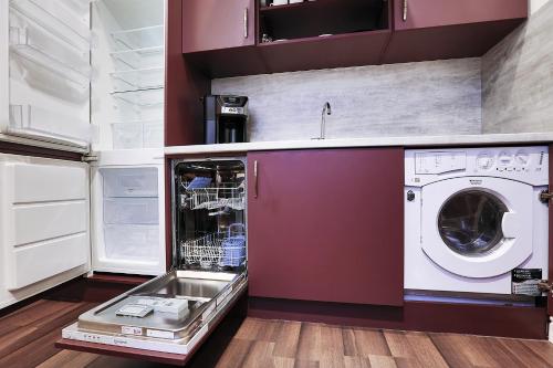 a laundry room with a washer and dryer at Two-bedroom Haven In The Old Town in Prague