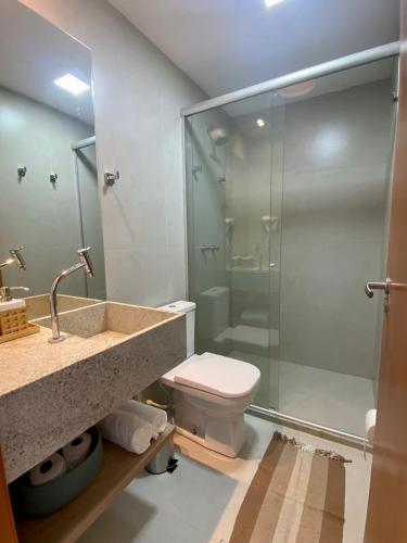 a bathroom with a shower and a toilet and a sink at TOCA GAMBOA in Pôrto de Pedras