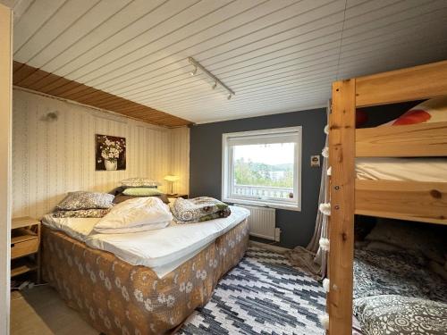 a bedroom with two bunk beds and a window at Very nice villa in northwestern Orust in Henån