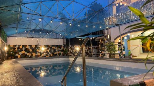 una piscina con luces en un edificio en villa paguio hot spring resort, en Calambá