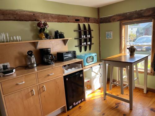 a kitchen with a counter and a table in it at Spellbound Farm in Union