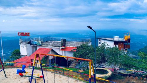a playground on top of a hill with a view at CHILLAX Resorts Palakkayam THATTU in Paithalmala