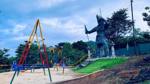 a statue in front of a playground with a statue at CHILLAX Resorts Palakkayam THATTU in Paithalmala