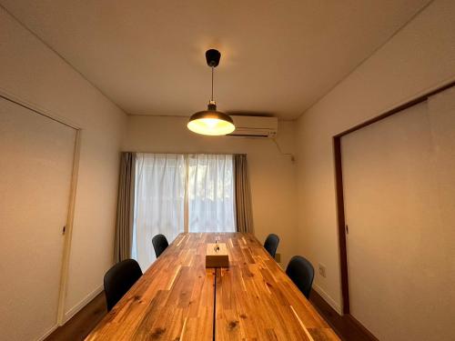 a conference room with a long wooden table and chairs at Shirako House in Shirako