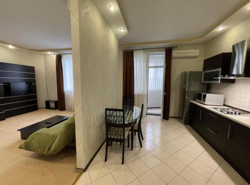 a kitchen with a table and a dining room at LUX central apartment in Dnipro