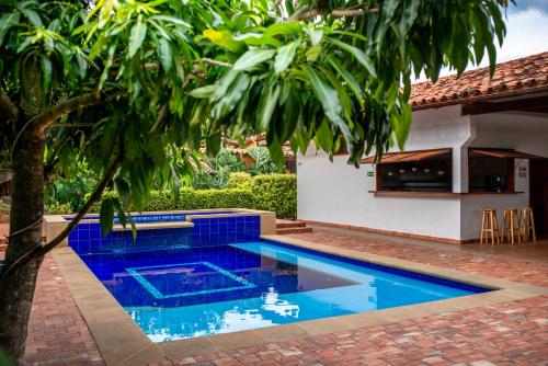 a swimming pool in a yard next to a house at Achiotte by Masaya Collection in Barichara