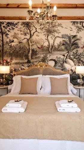 a bed with two white towels on top of it at La Flor del Camino Posada in Tanti