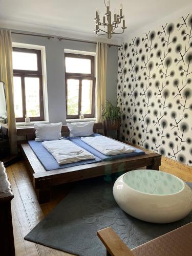 a bedroom with a large bed and a large window at Homeplanet Hostel in Leipzig
